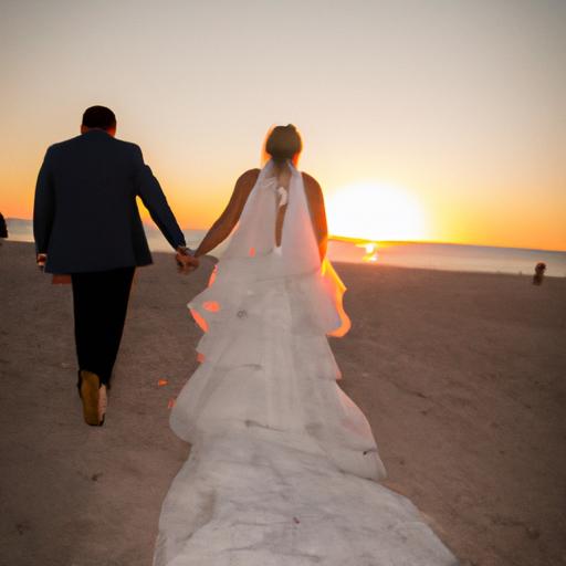 Cô dâu chú rể nắm tay nhau đi bộ trên bãi biển lúc hoàng hôn tạo nên khung cảnh đẹp như tranh vẽ cho album cưới ngoại cảnh.