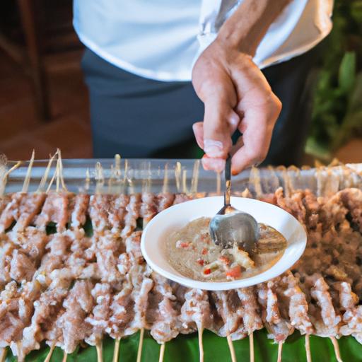 Đầu bếp cẩn thận xếp thịt heo đã ướp lên que tre cho món Nem Lụi, một món ăn phổ biến trong đám cưới miền Trung.